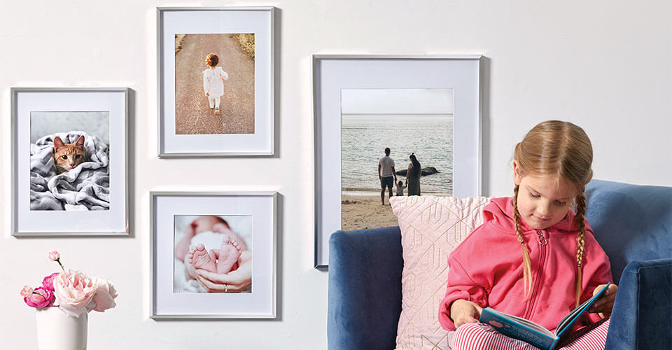 Use a variety of sized frames to create a gallery wall for your home.