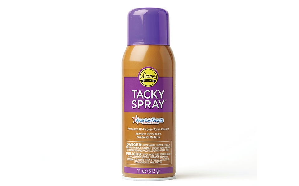 spray adhesive in a brown bottle with a purple lid