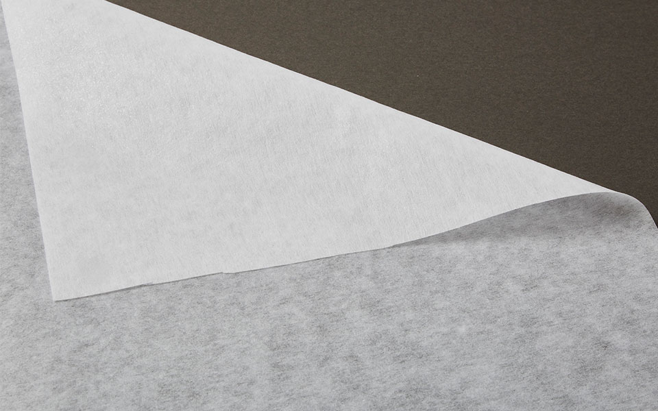 folder over corner of white woven interfacing fabric