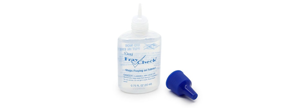 liquid fray protector in a clear bottle with a blue lid laying next to it