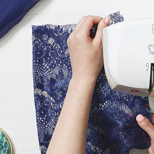 sewing machine sewing blue lace