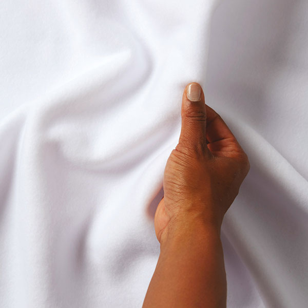 hand holding white blizzard fabric