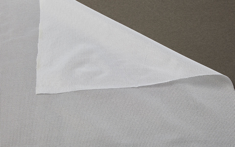 folder over corner of white knit interfacing fabric