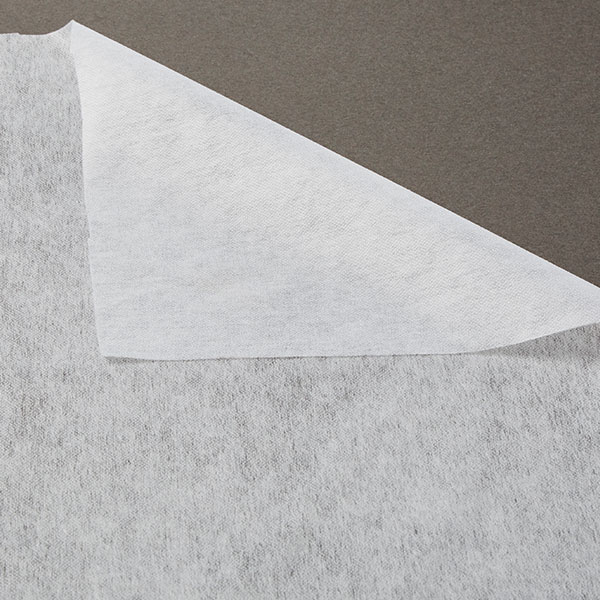 folder over corner of white fusible interfacing fabric