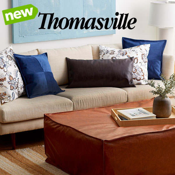 Thomasville fabric pillows on couch with leather ottoman