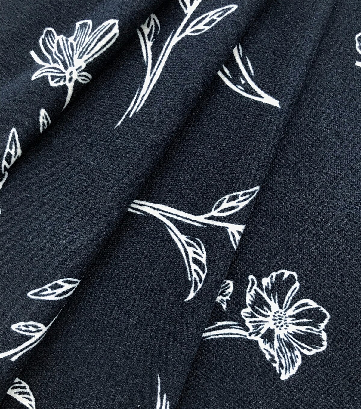 Ember White Illustrated Floral on Navy Knit Fabric | JOANN